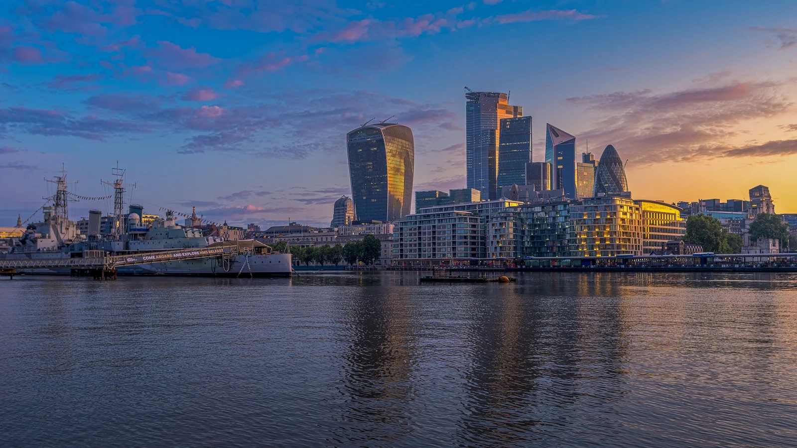 The City of London skyline across the Thames at dusk